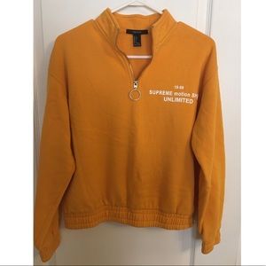 Orange 3/4 zip up sweater.